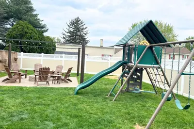 a playground with a slide in a yard at Amish Guest House - hottub, patio, swing, ebikes in Gordonville