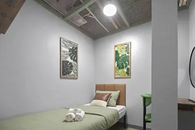 a bedroom with a bed with two towels on it at CityNest Hotel in New York