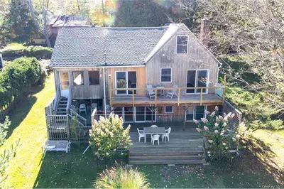 an aerial view of a house with a deck at Catskills Lakefront with Kayaks, HotTub & Firepit in Swan Lake