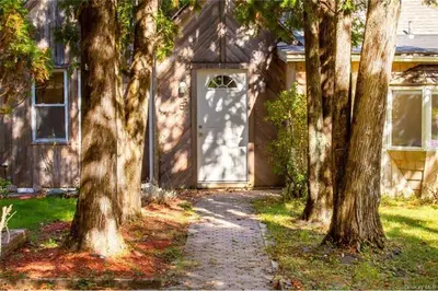 a house with a white door and some trees at Catskills Lakefront with Kayaks, HotTub & Firepit in Swan Lake