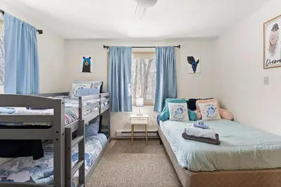 a bedroom with two bunk beds and a window at Vaulted Pines Lodge Hot Tub Game Room in Albrightsville
