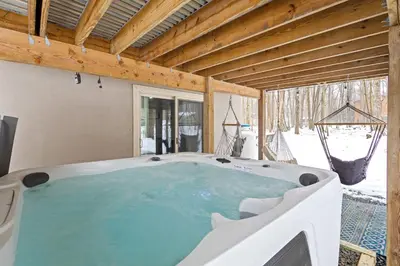 a jacuzzi tub in a room with at Vaulted Pines Lodge Hot Tub Game Room in Albrightsville