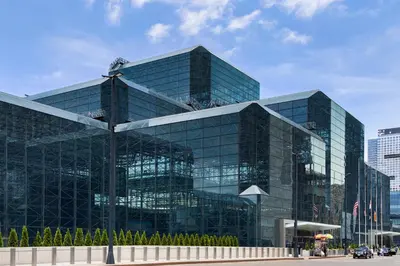 a large glass office building in a city at Holiday Inn New York City - Times Square by IHG in New York
