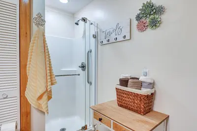 a bathroom with a shower and a basket of towels at Near State Parks Countryside Cottage in Wellsboro in Wellsboro