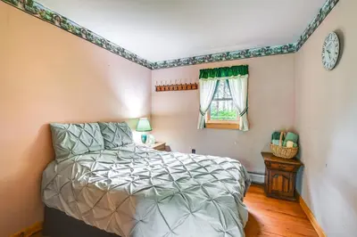a bedroom with a bed and a window at Near State Parks Countryside Cottage in Wellsboro in Wellsboro