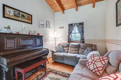 a living room with a piano and a couch at Near State Parks Countryside Cottage in Wellsboro in Wellsboro