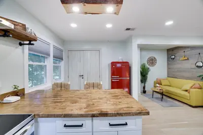 a kitchen with a red refrigerator and a living room at Apartment Minutes from Camelback Mountain with Washer Dryer in Tannersville