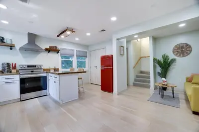 a kitchen and living room with a red refrigerator at Apartment Minutes from Camelback Mountain with Washer Dryer in Tannersville
