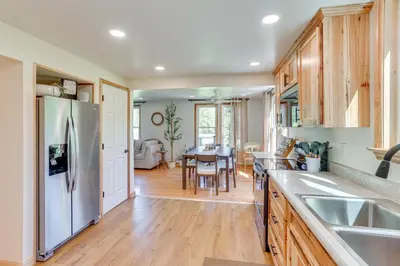 a kitchen with a refrigerator and a dining room at Steps to Susquehanna River Hot Tub Hideaway! in Dauphin