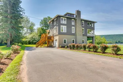 a large gray house with a ramp up a driveway at Steps to Susquehanna River Hot Tub Hideaway! in Dauphin