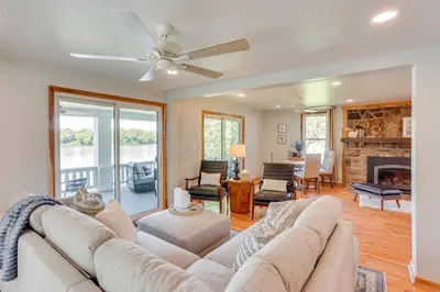 a living room with a couch and a fireplace at Steps to Susquehanna River Hot Tub Hideaway! in Dauphin
