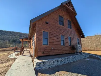 a log cabin with a pathway leading up to it at Fully Loaded Riverfront West Branch Fishing Cabin in Deposit
