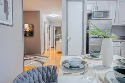 a kitchen with a table with a vase on it at Stylish 3BD Near Empire in New York