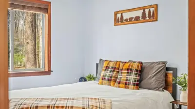 a bed with two pillows and a window at Access to Private Lake Pools Sports Complex • Fire Pit Foxden by AvantStay in East Stroudsburg