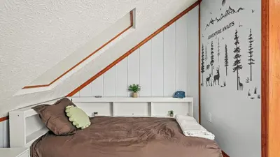 a bedroom with a bed under a staircase at Access to Private Lake Pools Sports Complex • Fire Pit Foxden by AvantStay in East Stroudsburg