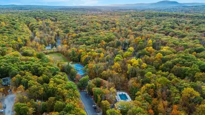 an aerial view of a forest with fall foliage at Access to Private Lake Pools Sports Complex • Fire Pit Foxden by AvantStay in East Stroudsburg