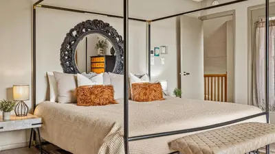 a bedroom with a bed with a large mirror at Emerald Bluff by AvantStay Lake Views Deck Fire Pit Game Room in Long Pond