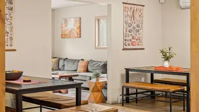 a living room with a couch and a table at Emerald Bluff by AvantStay Lake Views Deck Fire Pit Game Room in Long Pond