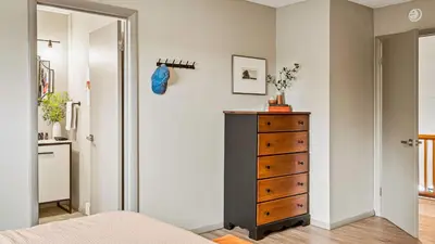 a bedroom with a dresser next to a door at Emerald Bluff by AvantStay Lake Views Deck Fire Pit Game Room in Long Pond