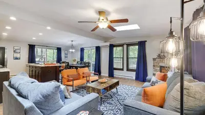 a living room with two couches and a table at Moshannon Tree-Lined Pocono Retreat w Hot Tub Firepit Pool Table in Pocono Lake