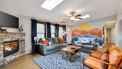 a living room with a couch and a fireplace at Moshannon Tree-Lined Pocono Retreat w Hot Tub Firepit Pool Table in Pocono Lake