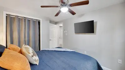 a bedroom with a bed and a ceiling fan at Moshannon Tree-Lined Pocono Retreat w Hot Tub Firepit Pool Table in Pocono Lake