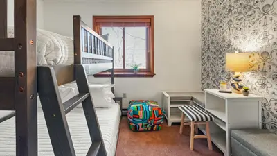 a small bedroom with a bunk bed and a desk at Pirate-Themed Lakefront Home w Kayaks Game Room Views Hidden Treasure Hunt in East Stroudsburg