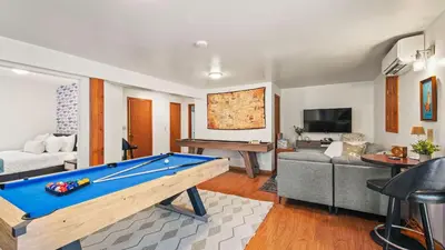 a living room with a pool table and a couch at Pirate-Themed Lakefront Home w Kayaks Game Room Views Hidden Treasure Hunt in East Stroudsburg