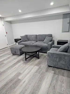 a living room with a couch and a table at Charming Twin Ponds Estate On 27 Acres in Woodbourne