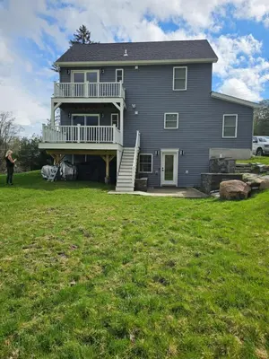 a large house with a large yard in front of it at Charming Twin Ponds Estate On 27 Acres in Woodbourne
