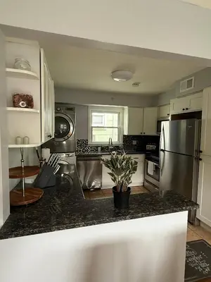 a kitchen with a stainless steel refrigerator and a counter at MetLife 10 Min 8 Guests Free Parking in Jersey City