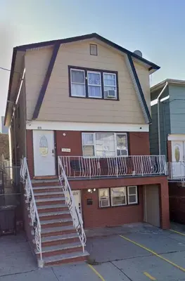 a house with stairs in front of it at MetLife 10 Min 8 Guests Free Parking in Jersey City
