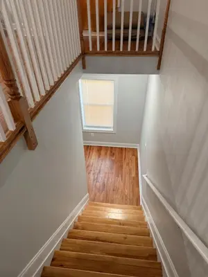 a staircase with a small window in a house at E&G homes in East Orange