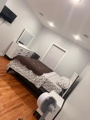 a bedroom with a bed with a dresser and a desk at E&G homes in East Orange