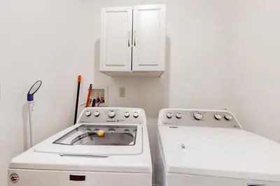 a white kitchen with a stove and a sink at Burntwood Retreat in East Stroudsburg