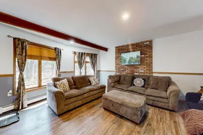 a living room with two couches and a fireplace at Burntwood Retreat in East Stroudsburg