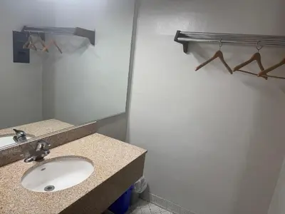 a bathroom with a sink and a mirror at Farrington Inn - North Brunswick in North Brunswick