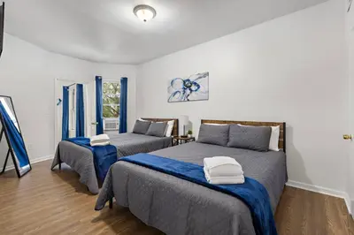 a bedroom with two beds and a window at Fun Family getaway - NYC & NWK w free parking in Newark