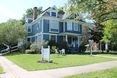 a blue house with a sign in front of it at The White Birch Inn in Berwick