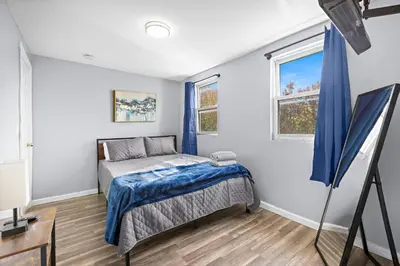 a bedroom with a bed and a window at Peaceful Hideaway - NYC & NWK with free parking in Newark