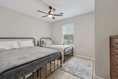 a bedroom with two beds and a ceiling fan at Renovated 6 bed Hot Tub Sauna Firepit & Beach in Lake Harmony