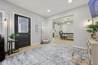 a living room with a black door and a rug at Renovated 6 bed Hot Tub Sauna Firepit & Beach in Lake Harmony