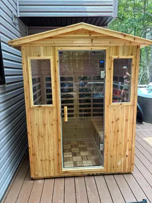 a wooden shed with a roof on a deck at Renovated 6 bed Hot Tub Sauna Firepit & Beach in Lake Harmony