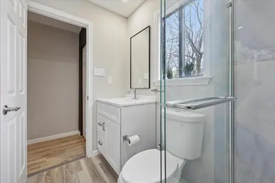 a bathroom with a toilet and a glass shower at Renovated 6 bed Hot Tub Sauna Firepit & Beach in Lake Harmony
