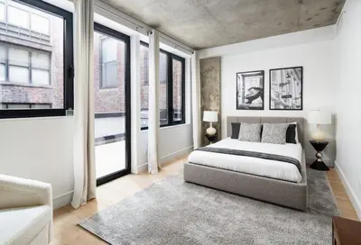 a bedroom with a bed and some windows at Stunning Apartment in Manhattan with Patio in New York