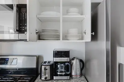a kitchen with a coffeemaker and a coffee maker at Blueground Battery Park City rooftop nr Hudson River NYC-291 in New York