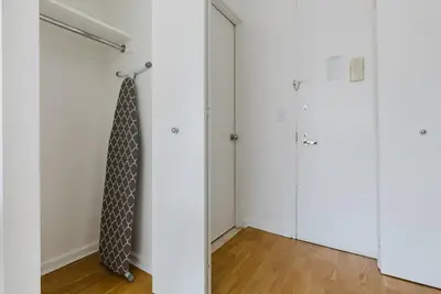 a room with a tie hanging on a door at Blueground Battery Park City rooftop nr Hudson River NYC-291 in New York
