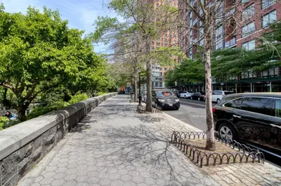 a sidewalk with trees and cars parked on a street at Blueground Battery Park City rooftop nr Hudson River NYC-291 in New York