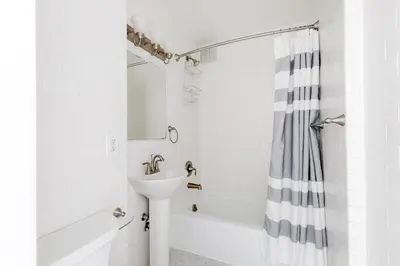 a white bathroom with a sink and a tub at Blueground Upper West Side wd nr Central Park NYC-1860 in New York