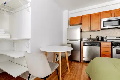a small kitchen with a table and a table and chairs at Blueground Upper West Side wd nr Central Park NYC-1860 in New York